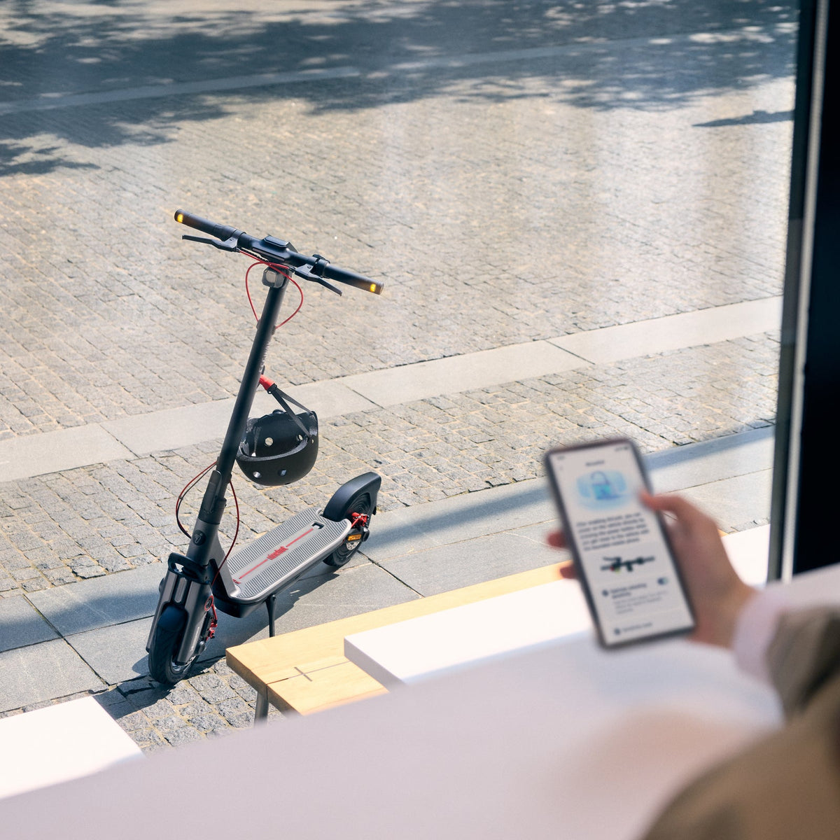 Segway F3 Pro parked outside while a rider checks their phone