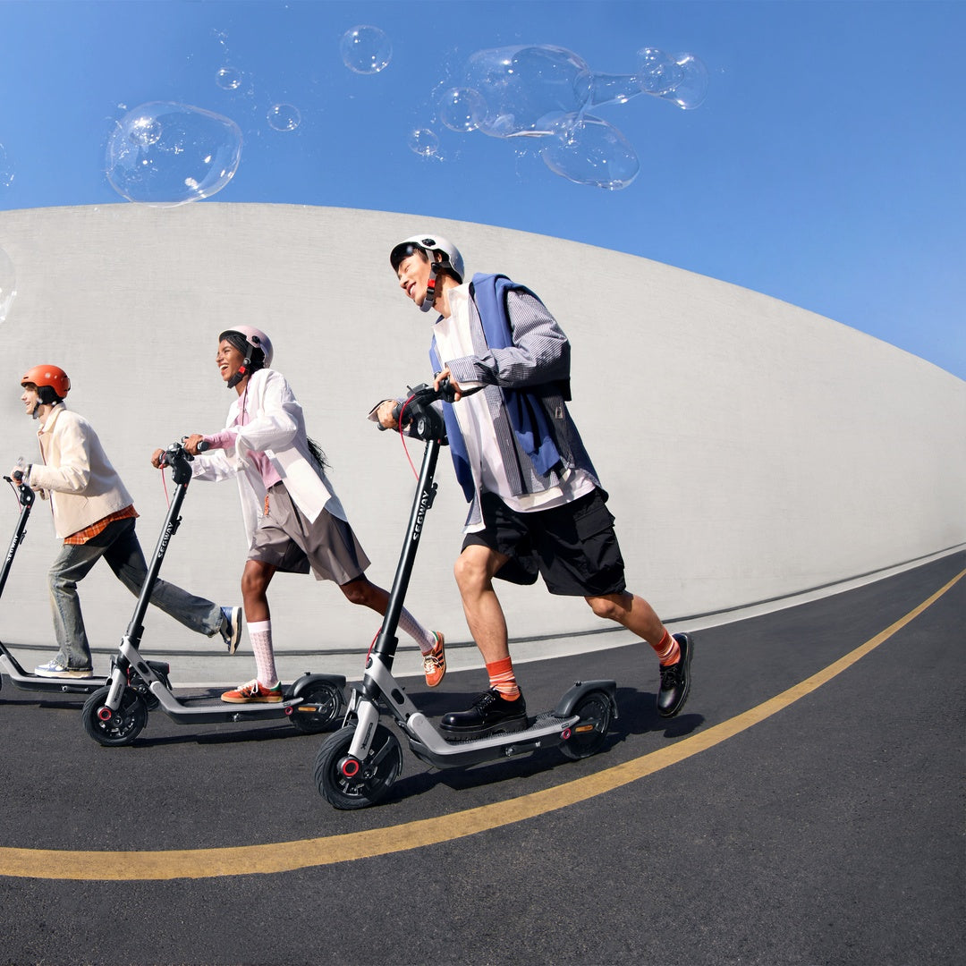 Group riding Segway E3-series scooters outdoors