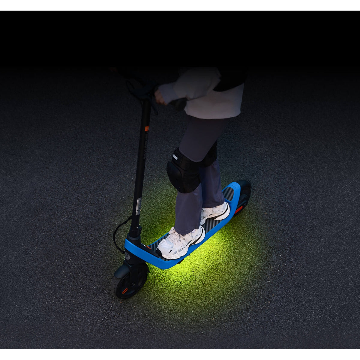 Segway Ninebot C2 Lite under-deck RGB lighting illuminating the ground beneath the scooter.