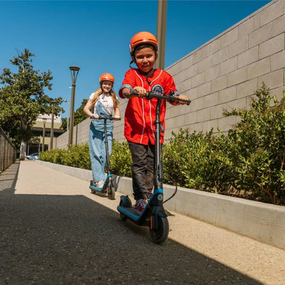 Helmeted children riding Segway C2 Pro scooters outdoors