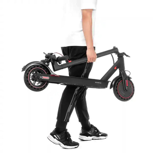 A person carrying the folded Redback Model S electric scooter by its stem.