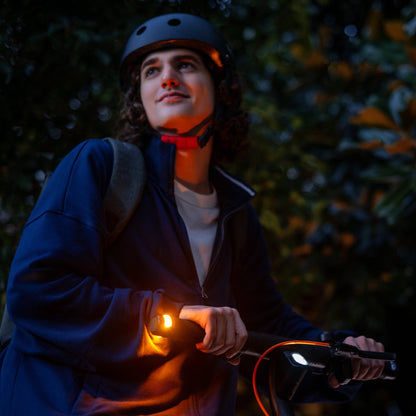 Helmeted E2 Pro rider with the handlebar indicator illuminated