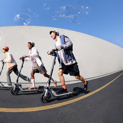 Group riding Segway E3-series scooters outdoors