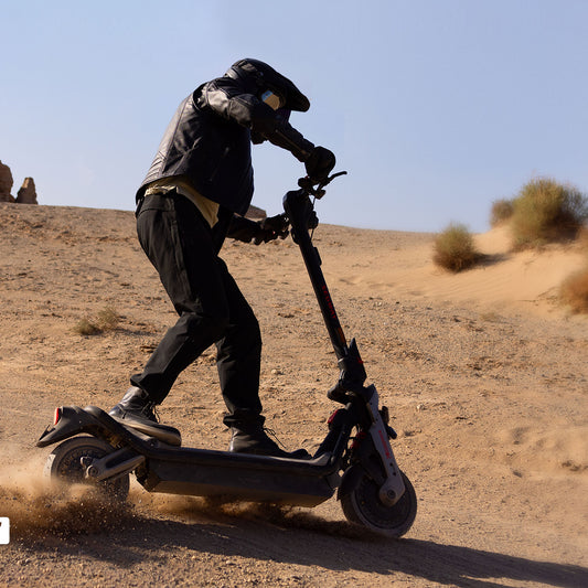 Segway Ninebot GT3 PRO electric scooter — helmeted rider using the scooter on a dry outdoor track