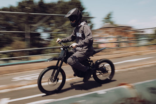 Talaria XXX PRO electric dirt bike ridden outdoors by a helmeted rider.